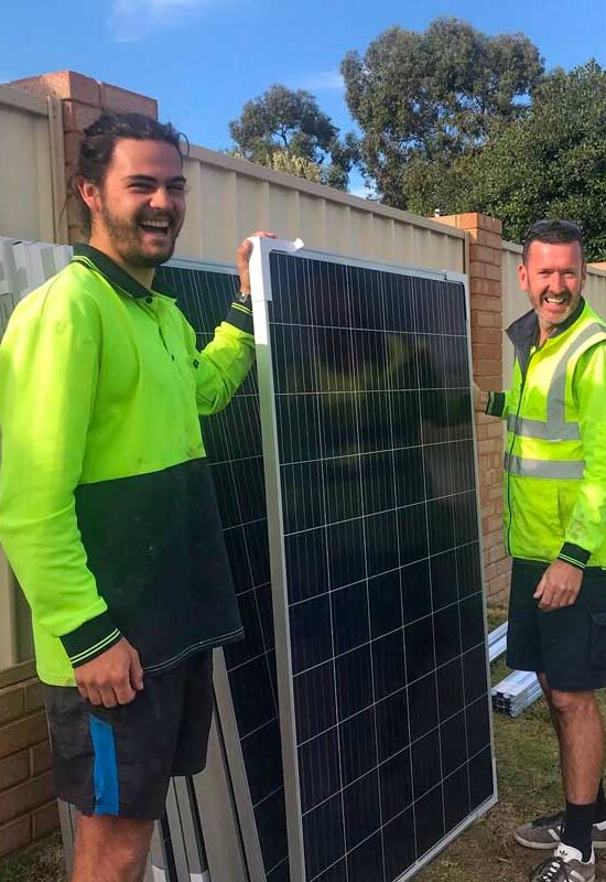 Green Sun Solutions solar installation team Green Sun Solutions team members holding a solar panel during installation