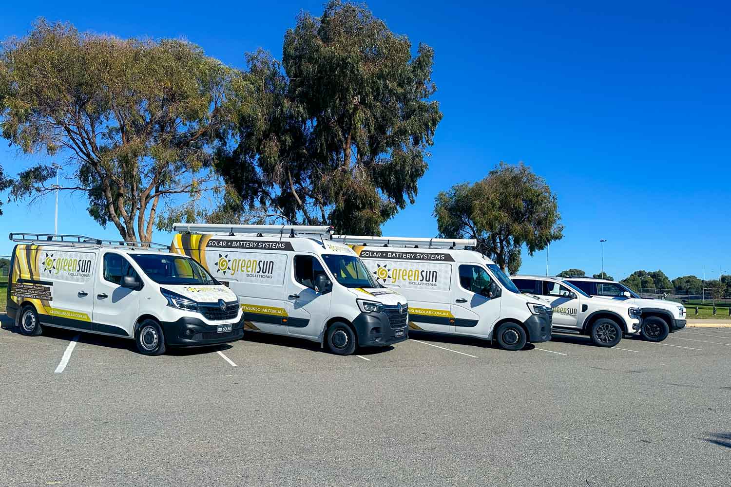 Green Sun Solutions fleet of vans and Utes with company branding