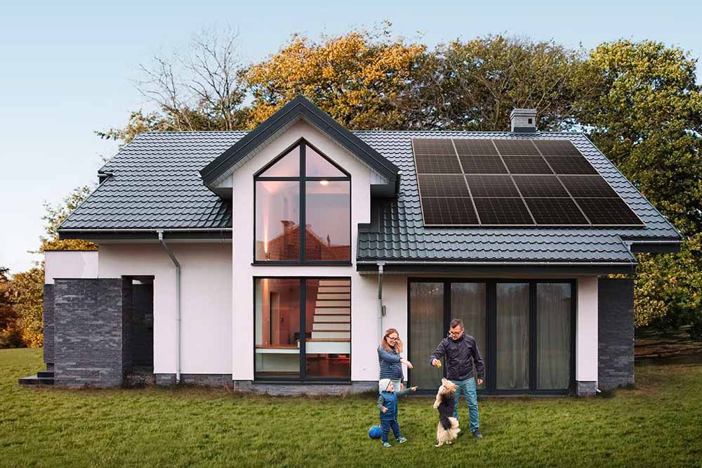 Family home with solar panels Family enjoying the outdoors near a home with solar panels